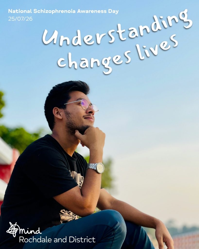 Man wearing glasses sits looking upwards in hope